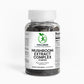 A bottle of Mushroom Extract Complex capsules next to dried medicinal mushrooms, emphasizing its immune-boosting and cognitive health benefits.

